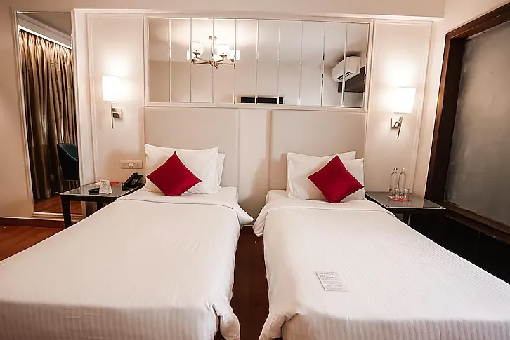 Deluxe room at Ramada by Wyndham Jaipur with king bed, work desk, and soft lighting setup