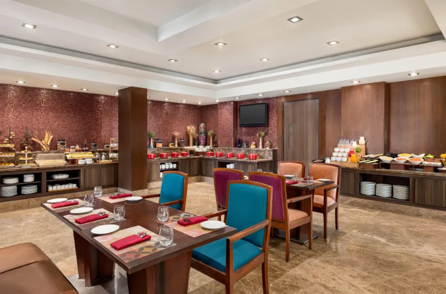 Hotel entrance of Ramada by Wyndham Jaipur with exterior frontage and driveway access