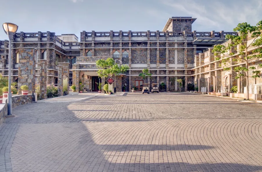 Hotel entrance of Ramada by Wyndham Udaipur Resort and Spa Udaipur with exterior façade and driveway approach