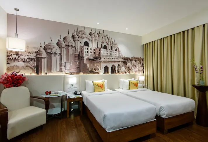 Deluxe room at Regenta Central Jaipur with king or twin bed, side tables, and clean layout