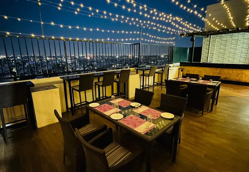 Restaurant at Regenta Central Jaipur showing dining tables, chairs, and interior setup