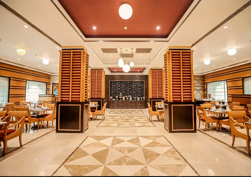 Restaurant space at Regenta Central Lucknow with dining tables, chairs, and ambient lighting