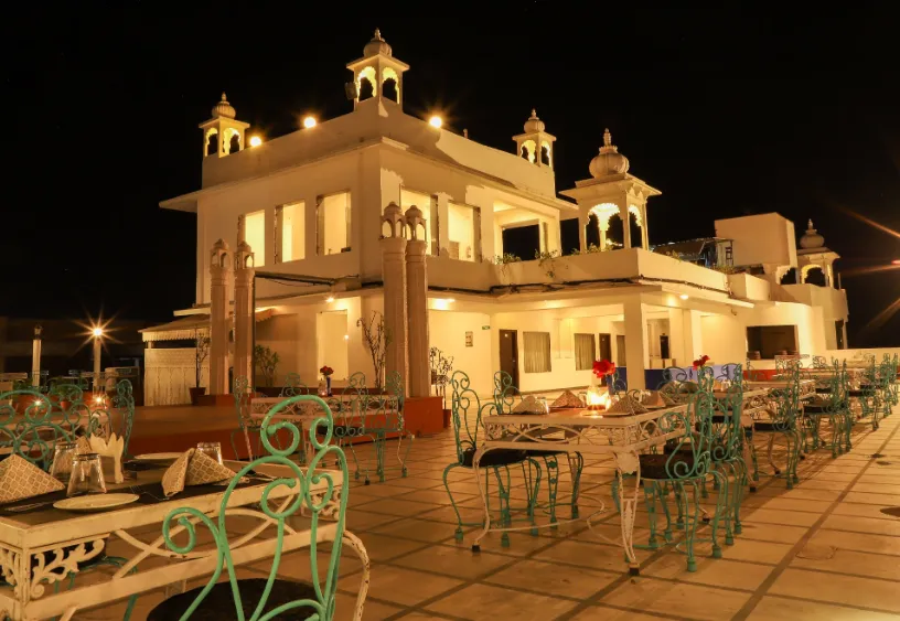 Restaurant at Regenta Central Mewargarh Udaipur displaying dining tables, place settings, and warm lighting
