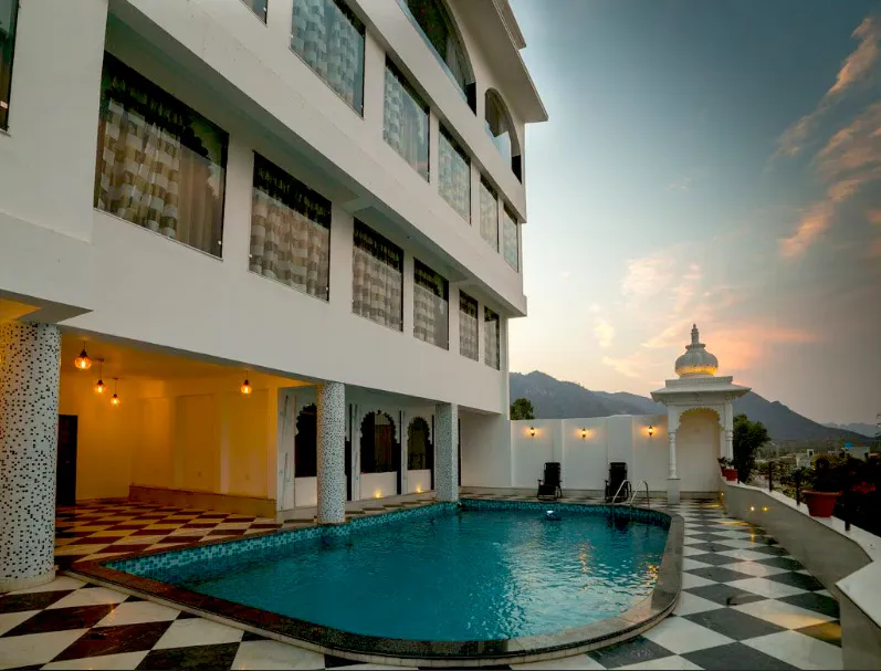 Restaurant at Regenta Central Mewargarh Udaipur displaying dining tables, place settings, and warm lighting