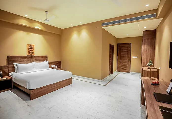 Premium room at Regenta Gulab Kothi Varanasi with refined interiors, double bed, and work-friendly lighting