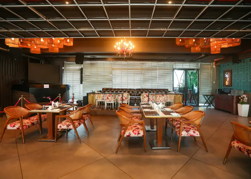 Restaurant at Regenta Place Jhansi Gorakhpur displaying dining tables, chairs, and well-lit interior space