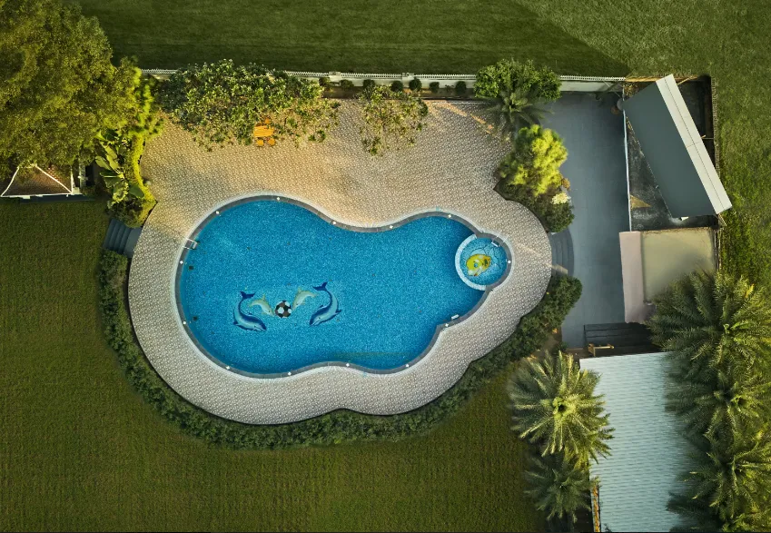 Swimming pool at Royal Kingdom Resort Pilibhit Pilibhit with open deck and surrounding space