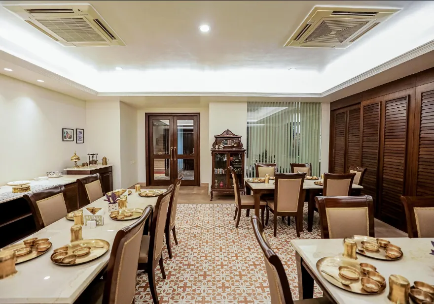 Restaurant at Saptapuri Varanasi by REGENTA Varanasi displaying dining tables and interior arrangement