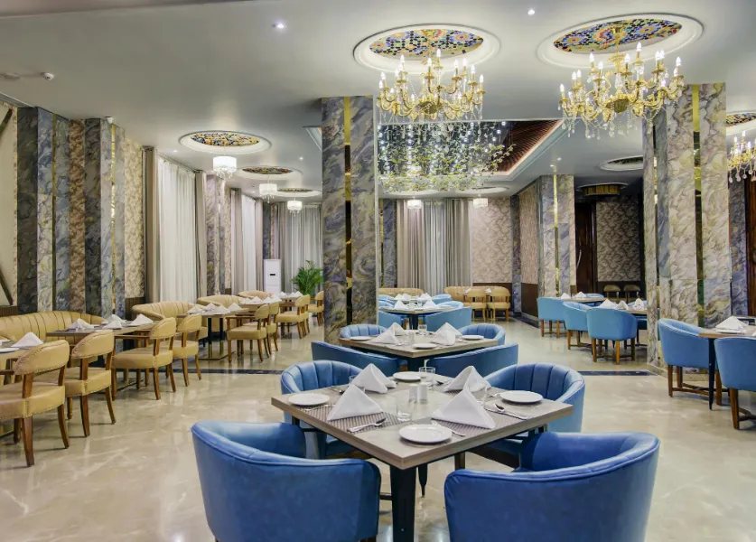 Restaurant at Sarovar Portico Saharanpur with arranged dining tables and indoor lighting