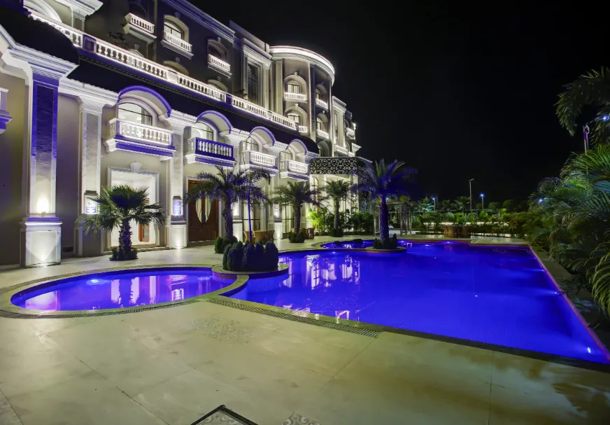 Swimming pool at Sarovar Portico Saharanpur with open deck and surrounding seating