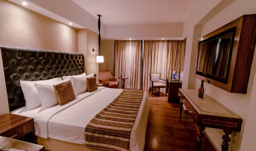 premium room at Sarovar Portico Jaipur with upgraded interiors, seating space, and modern layout