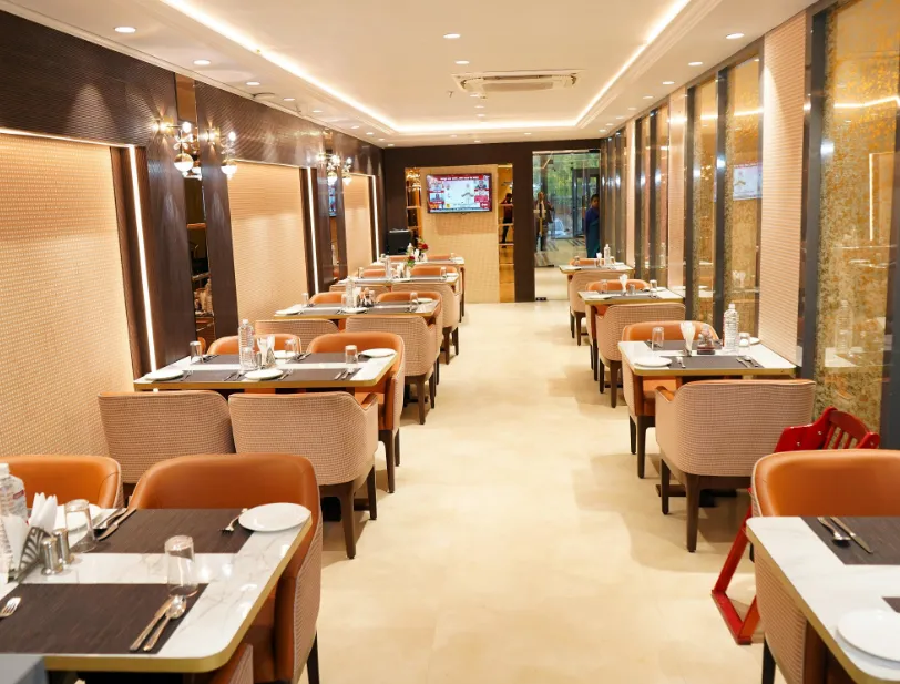 Restaurant at Shrigo Hotels Banaras Varanasi with dining tables, chairs, and organized service space