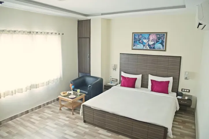 Executive room at Spring Sky by ShriGo Hotels Mughalsarai with neatly arranged bed and simple interiors