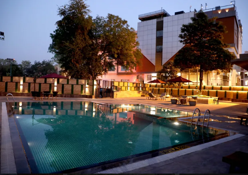 Restaurant area at The Fern Residency Udaipur with dining tables, lighting fixtures, and service layout