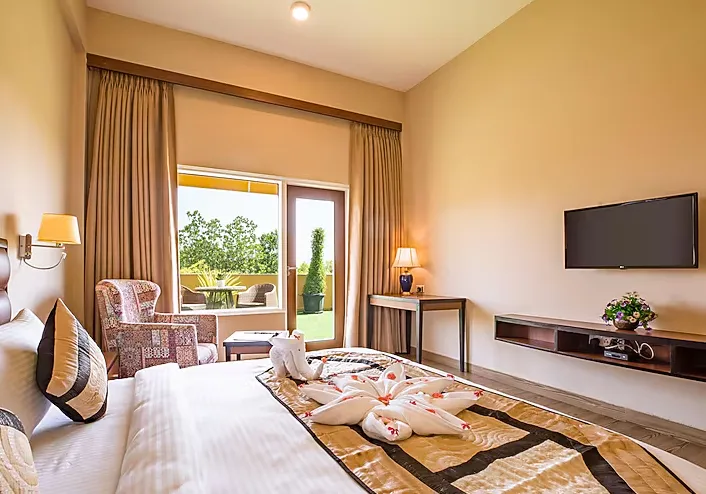 Executive room at The Lalita Grand Mathura with bed setup, side tables, and soft interior lighting
