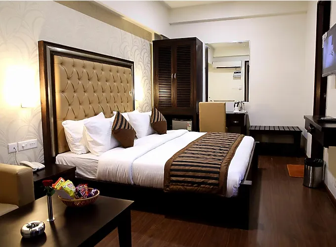 Deluxe room at The Raj Vilas Agra showing larger layout, seating space, and window illumination