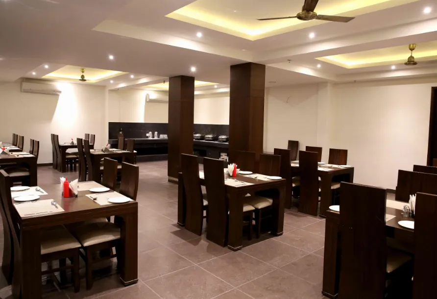 Restaurant at The Raj Vilas Agra with dining tables, chairs, and ambient lighting setup