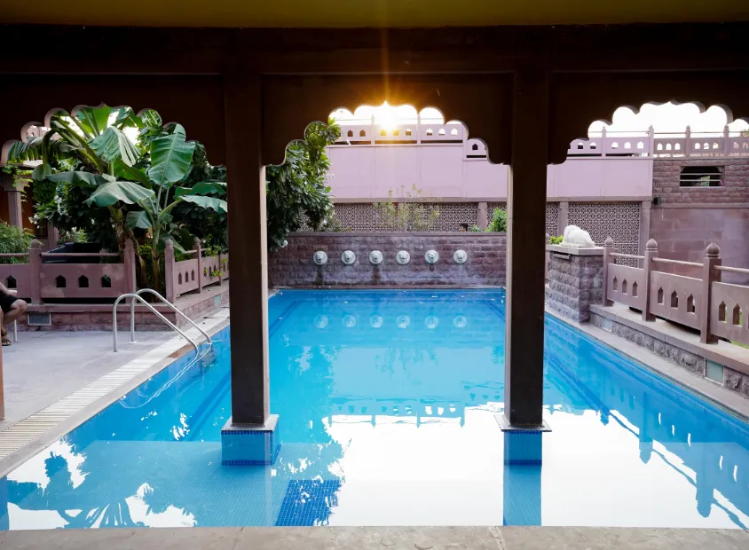 Swimming pool at Treehouse Rajbagh Jodhpur with clear water and poolside seating