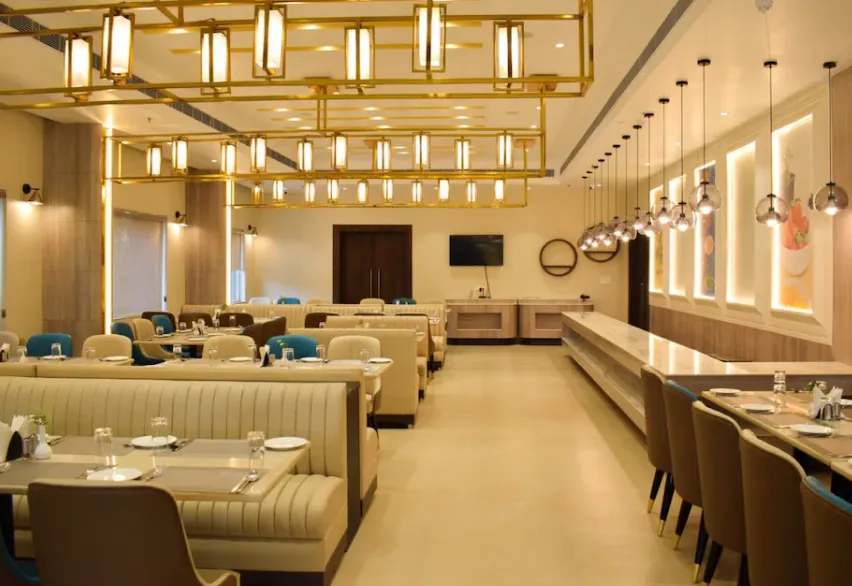 Restaurant at Tulip Inn Shravasti with dining tables arranged in indoor setting