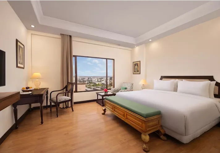 Premium room at V Sarovar Portico MI Road Jaipur showing bed placement and clean interior layout