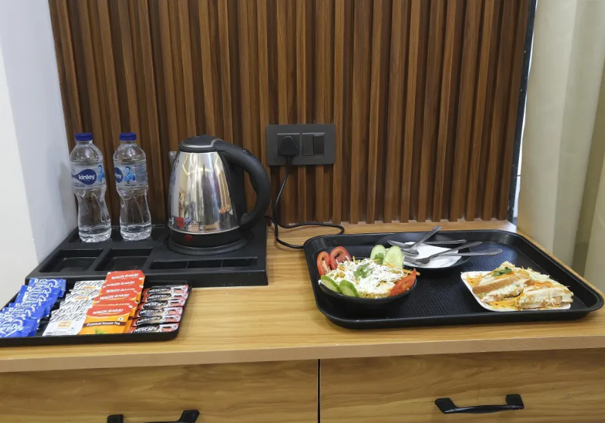 Restaurant at Vasu Palace Ayodhya with dining tables and indoor meal setup