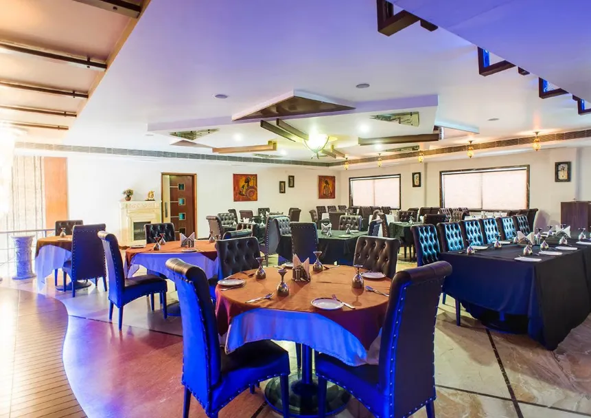 Restaurant at Wingston A Treehouse Hotel Mathura with dining tables and warm lighting