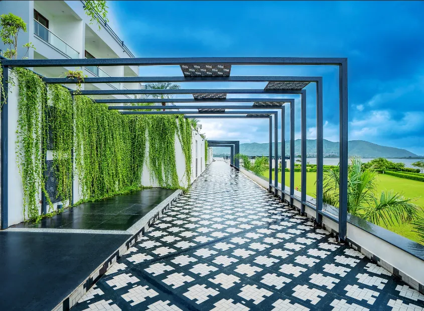 Exterior entrance of Zana Lake Resort Udaipur with driveway and façade