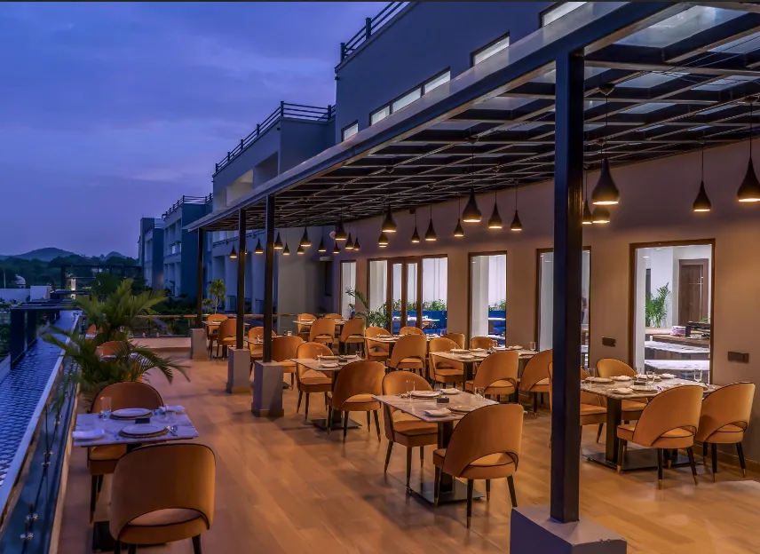 Restaurant at Zana Lake Resort Udaipur displaying dining tables and interior space