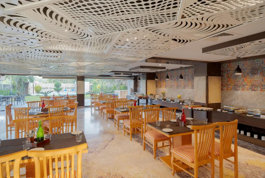 Restaurant at Zone Connect by The Park Udaipur displaying dining tables, lighting, and service counters