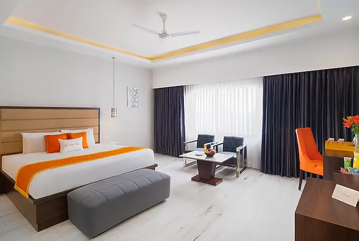 Suite room at Zone Connect by The Park Udaipur showing separate seating and sleeping zones