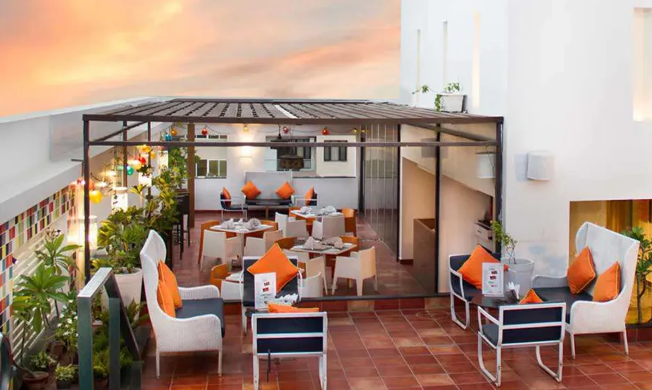 Restaurant at Zone by The Park Hotel Jaipur displaying dining tables, décor, and service counter