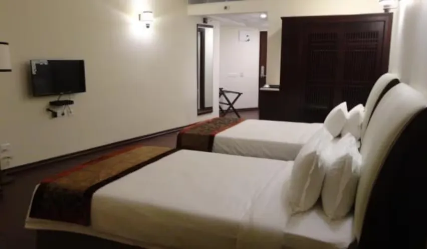 the_fern_residency_asansol_the_fern_club two beds in a room