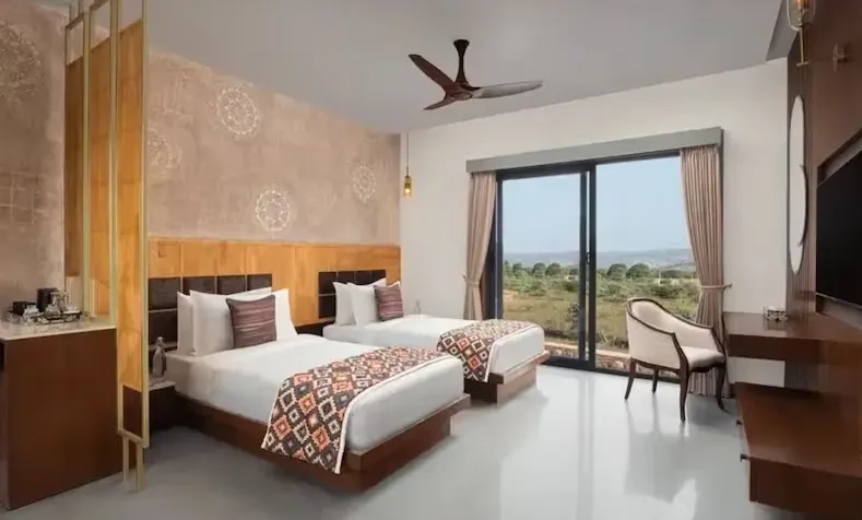 Premium twin room at Bookmark Resorts Jogi Mahal Ranthambore with twin beds and natural lighting