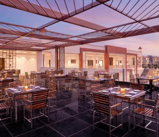 Restaurant at Bookmark Resorts Jogi Mahal Ranthambore displaying dining tables and interior setting