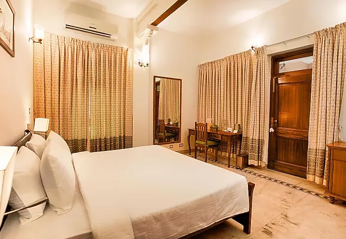 Superior room at Club Mahindra Bharatpur with bed and soft lighting