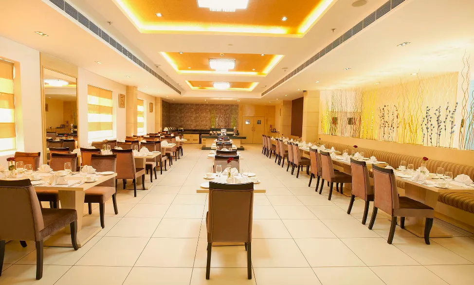 Entrance of Days Hotel by Wyndham Neemrana with hotel façade and driveway