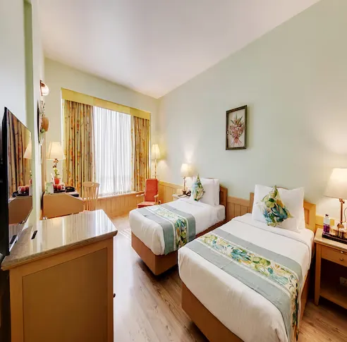 E-Square-The-Fern-Pune-winter-green-room-2twinbed