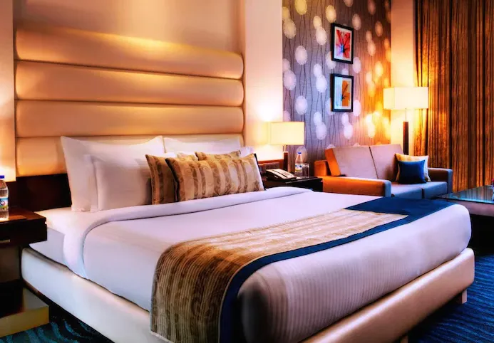 Superior room at Golden Tulip BDI Club And Suites Bhiwadi with bed and décor