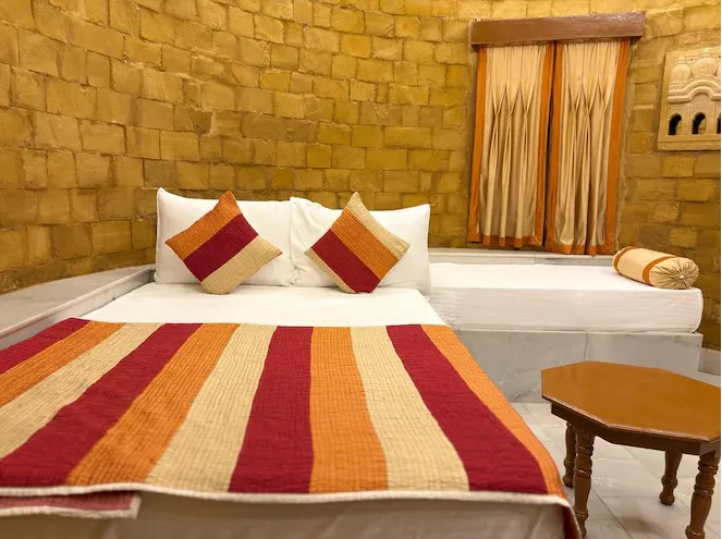 Burj Fort View Room at Himmatgarh Palace Jaisalmer with bed and skyline view
