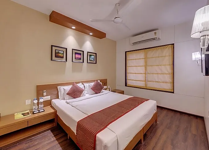 Suite room at Hotel Grand Fortune Beacon Kohlapur with separate living space and bedroom