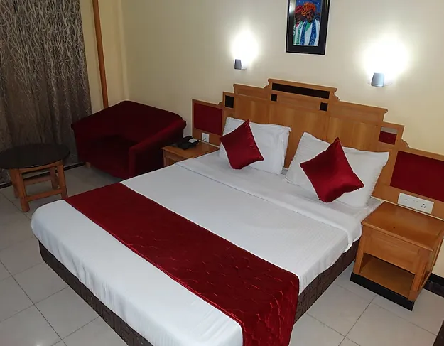 Executive room at Kalyan Residency Tirupati with bed and functional layout