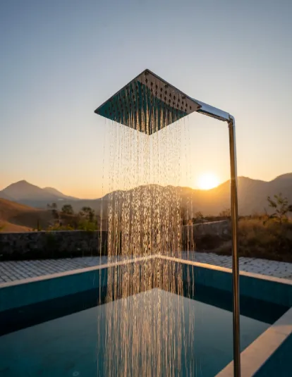 Outdoor swimming pool at Kavish Kutumb Villa Kumbhalgarh with deck and surrounding greenery