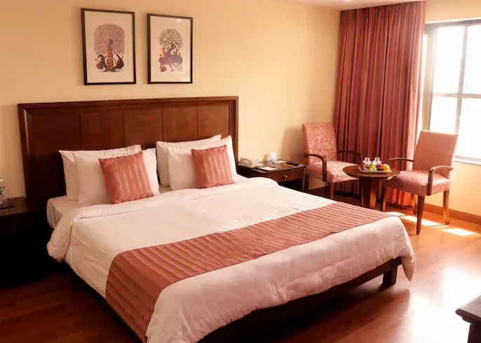 Executive room at Le Lac Sarovar Portico Ranchi with bed and workspace setup