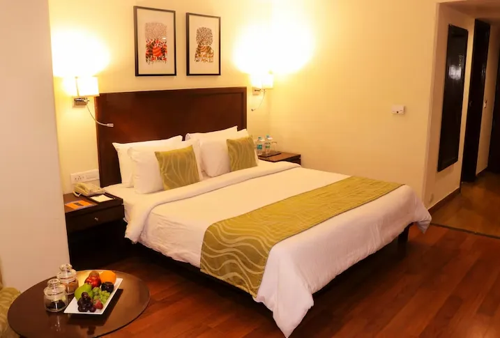Superior room at Le Lac Sarovar Portico Ranchi with comfortable bed and work desk