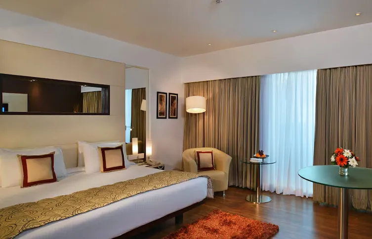 Superior room at Majestic Court Sarovar Portico Navi Mumbai with tidy bedding
