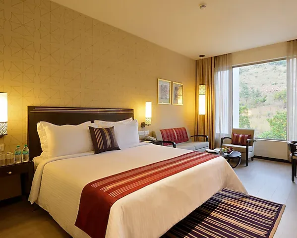 Deluxe room at Marasa Sarovar Premiere Tirupati showing bed and work desk