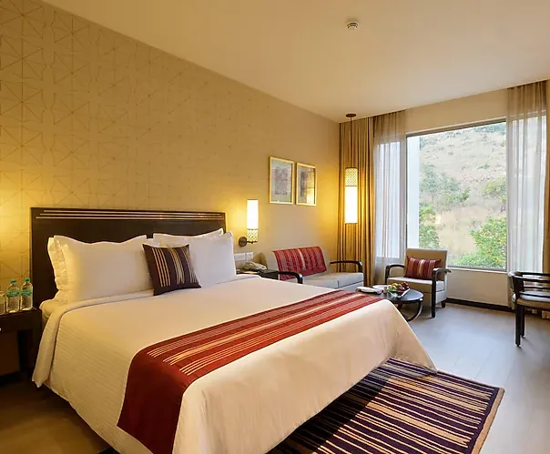 Premium style room at Marasa Sarovar Premiere Tirupati with large bed and seating