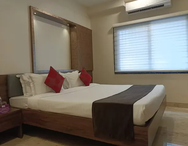 Deluxe room at Purplebeds by VITS Aurangabad showing bed, lighting, and seating