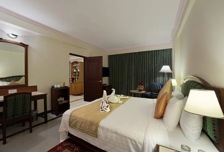 Suite room at Radha Regent Chennai Chennai with separate living area and bedroom setup