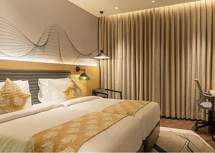 Deluxe room at Ramada Encore By Wyndham Bhiwadi featuring king bed and clean interior design